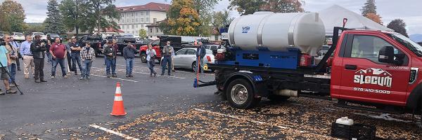 Participants at the Adirondack-Champlain Regional Salt Summit held October 14, 2021 in Lake George, NY. People stand in parking lot with road salt truck